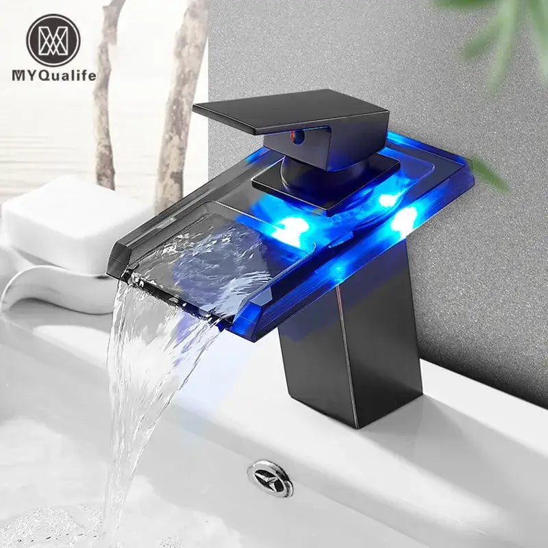 Matte black led waterfall basin faucet with translucent blue glass panel illuminated by embedded decorbites led waterfall lights