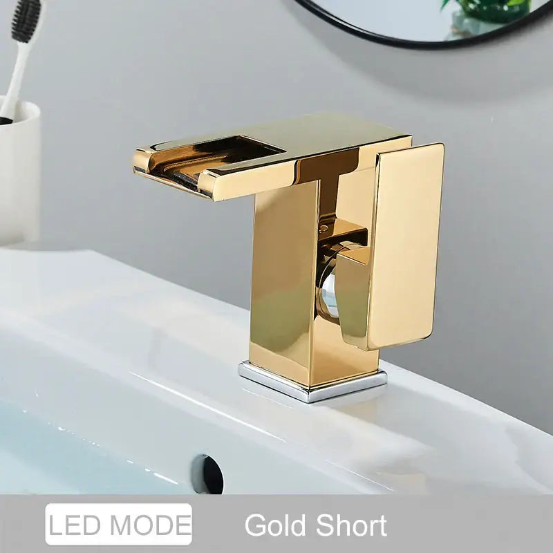 Gold-colored modern short basin faucet with sleek rectangular design and polished metallic finish for decorbites led waterfall