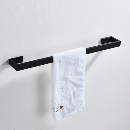 Matte black metal bathroom hardware set featuring a towel rack with rectangular ends holding a white textured towel