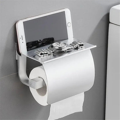 Matte black and silver metallic toilet paper holder with built-in shelf for smartphone and watch bathroom storage