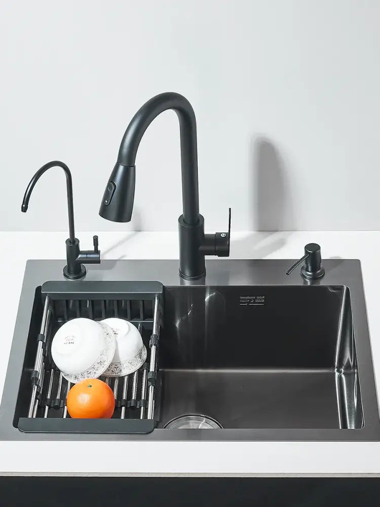 Matte black stainless steel kitchen sink with integrated pull-out faucet and side sprayer featuring modern design