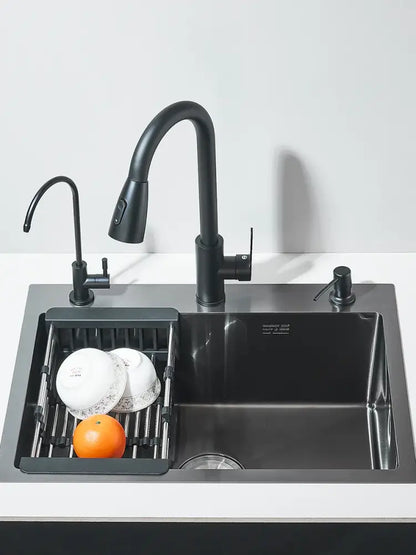 Matte black stainless steel kitchen sink with integrated pull-out faucet and side sprayer featuring modern design
