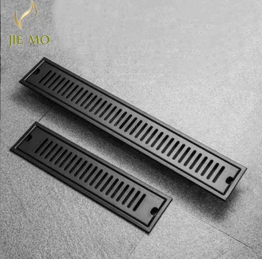 Matte black stainless steel strip floor drain grate with evenly spaced slots for bathroom shower use