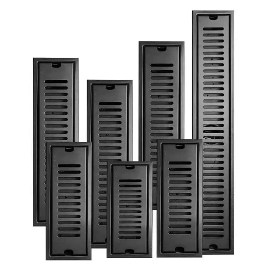 Set of matte black stainless steel strip floor drains with slotted grates for bathroom shower use