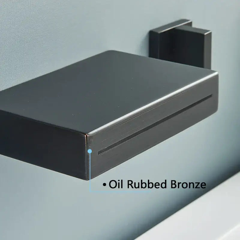 Oil rubbed bronze wall mounted soap dish with sleek rectangular design and brushed metal finish for mounted waterfall bathroom use