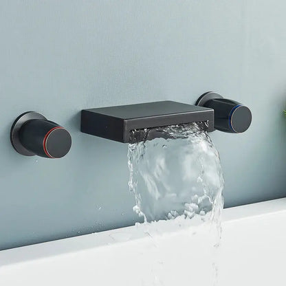 Matte black wall mounted waterfall bathroom faucet with dual cylindrical handles accented with red and blue rings