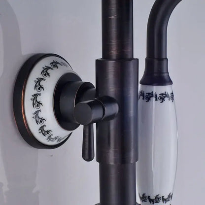 Matte black and white ceramic shower faucet set with black matte brass finish and ornate scrollwork handles for bathroom use