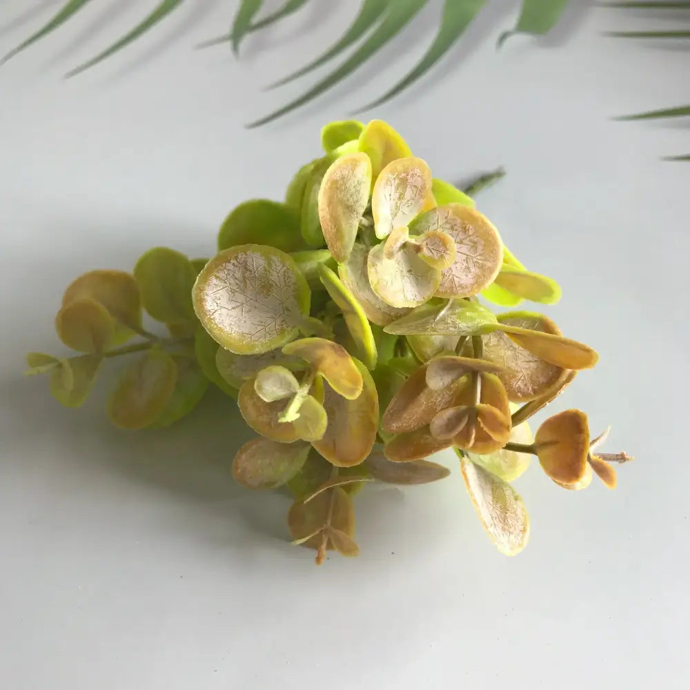 A cluster of decorbites artificial ferns shrubs with matte gold silver and green leaves featuring detailed vein patterns for living room decor