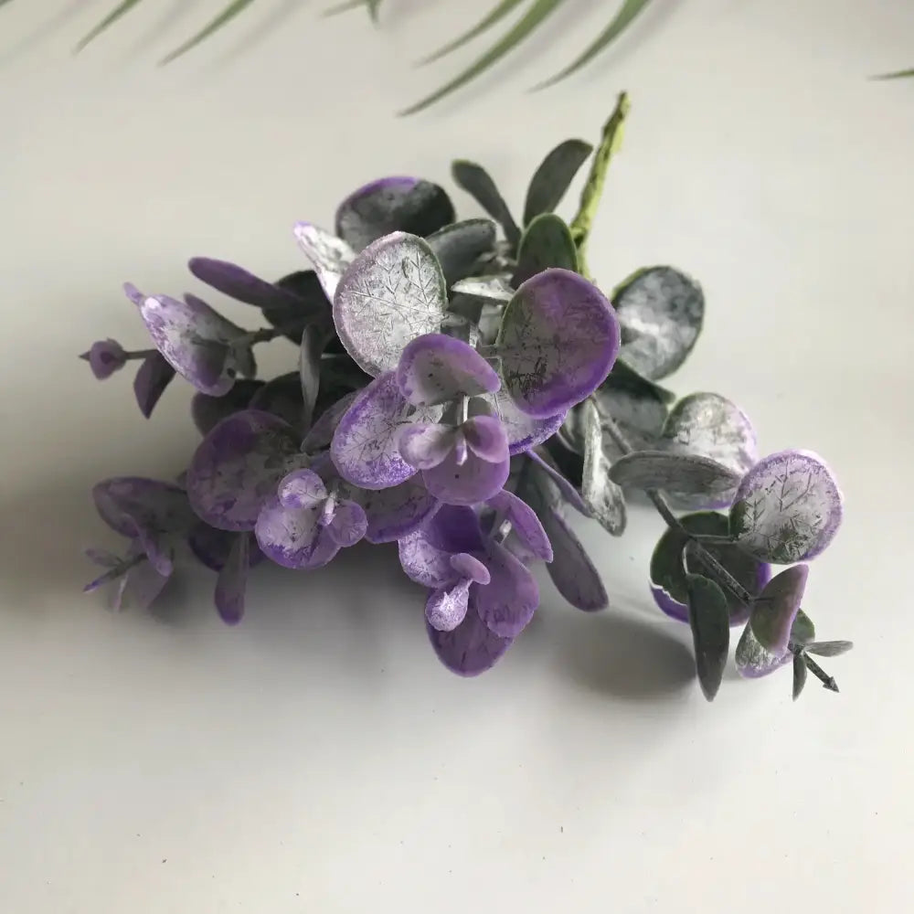 A cluster of purple and silver artificial eucalyptus leaves with textured veins in decorbites artificial ferns shrubs living room decor