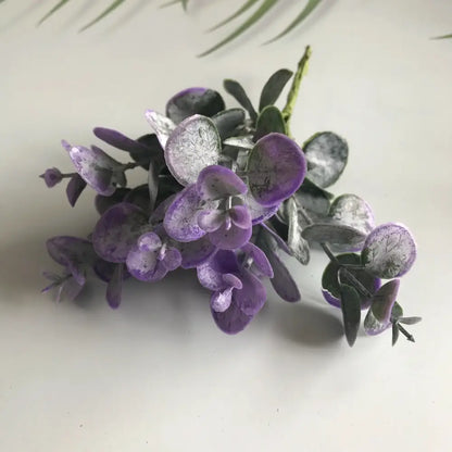 A cluster of purple and silver artificial eucalyptus leaves with textured veins in decorbites artificial ferns shrubs living room decor