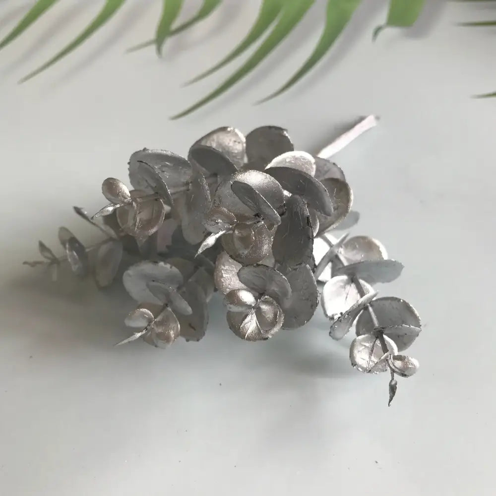 Matte gold, silver, and green artificial ferns shrubs featuring silver metallic eucalyptus leaf cluster decorbites artificial ferns decor