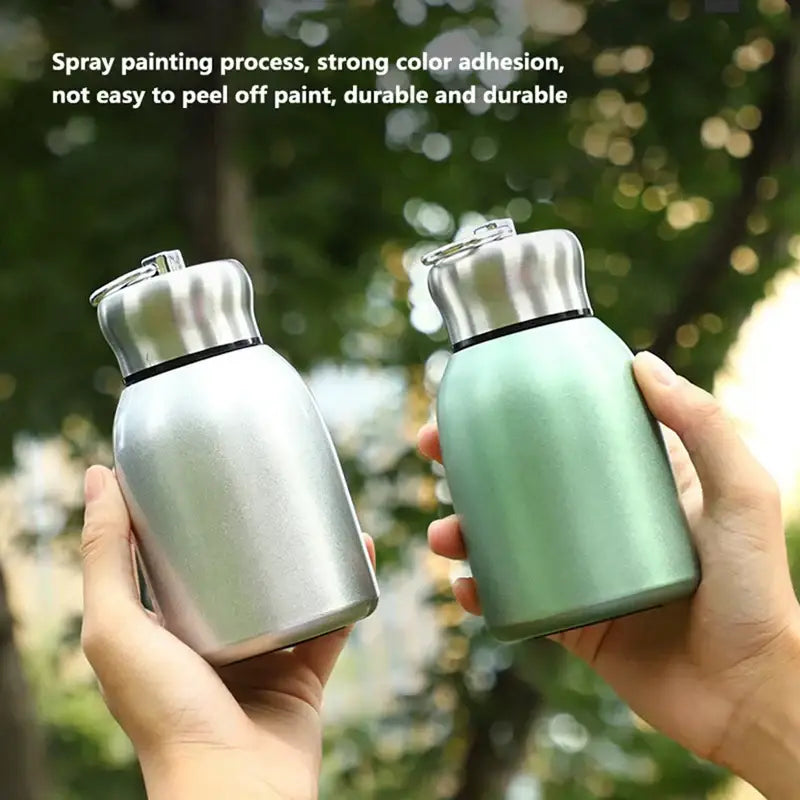 Matte pastel stainless steel vacuum flask water bottles in silver and mint green with sleek rounded designs for travel