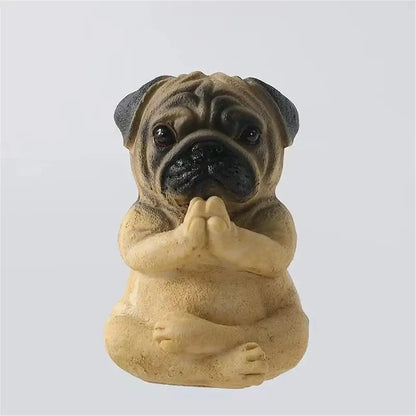 A tan and black pug bulldog resin statue in meditative pose with clasped paws from decorbites bulldog resin set