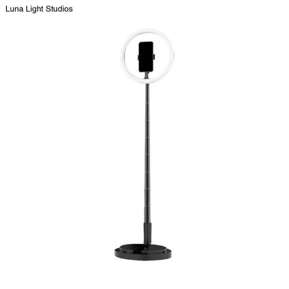 Metallic black led makeup lamp with phone holder on adjustable telescopic pole and stable circular base for bedroom use