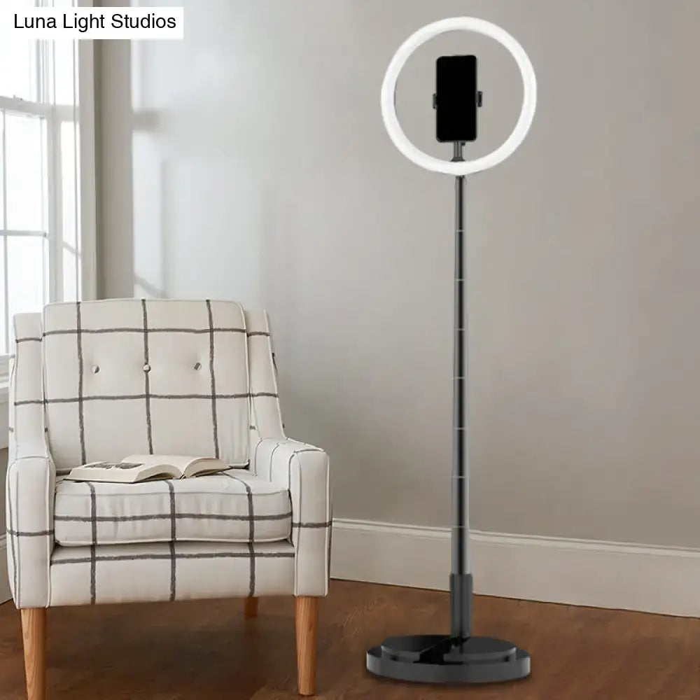 Metallic black led makeup lamp with phone holder featuring a sleek ring light on an adjustable stand for bedroom use