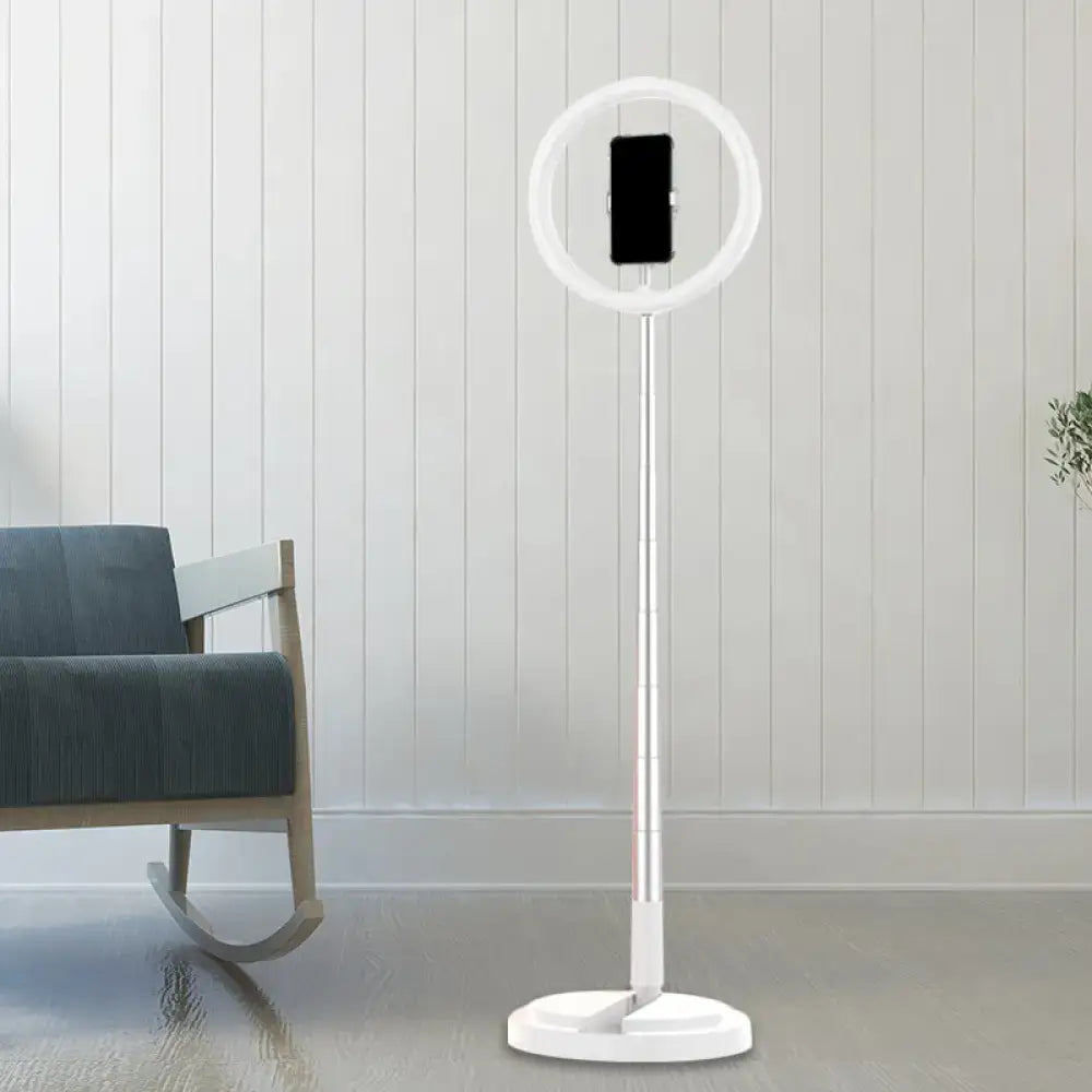 Metallic black led makeup lamp with a white ring light and phone holder mounted on a slender pole for bedroom use