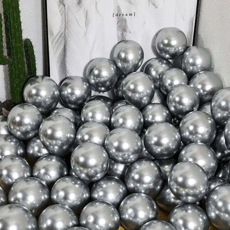A pile of shiny metallic silver balloons from a chrome golden balloons pack of 10 for wedding party decor