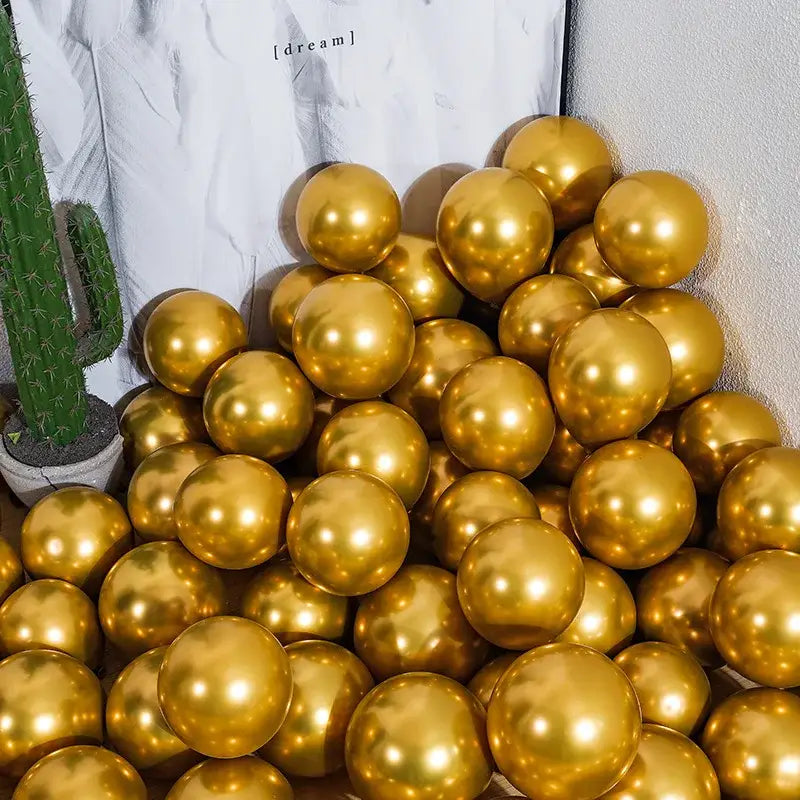 A pile of shiny chrome golden balloons made of metallic material for wedding party decor pack of 10