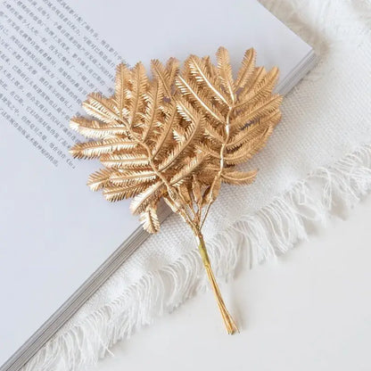 Gold metallic palm leaves brooch with intricate leaf detailing and slender stem for decorbites gold palm decorbites gold palm leaves decor