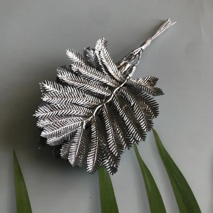 Silver metallic artificial eucalyptus leaf brooch with detailed veining and textured surface for living room decor