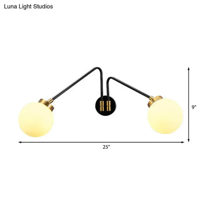 Black and brass two-arm mid century wall sconce with frosted opal glass globes compatible with e26 e27 bulbs