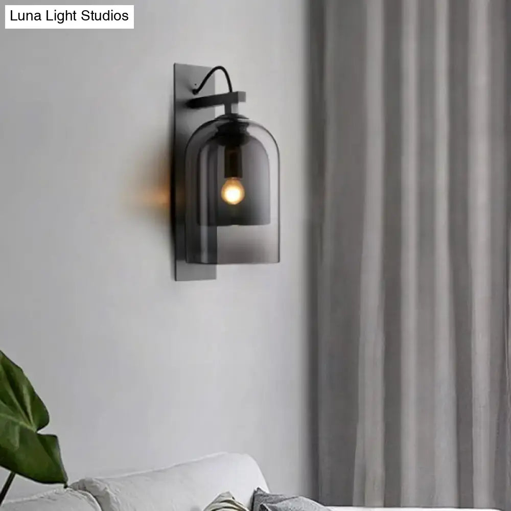 Mid-century black metal wall sconce with smoked dome glass shade featuring a glass shade approximately 8 inches wide for living room use
