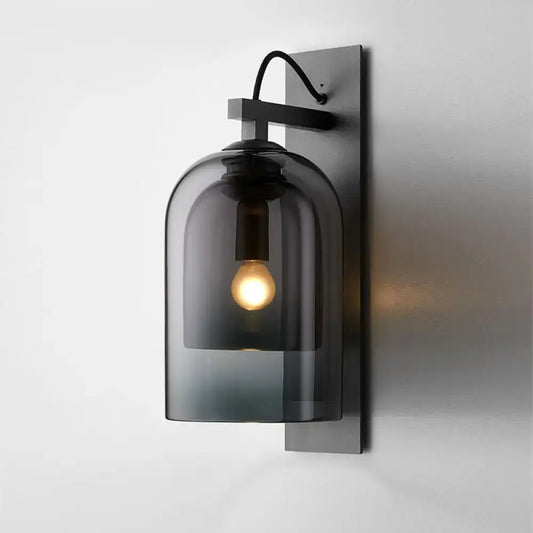 Mid-century black wall sconce with dark gray smoked dome glass shade and black metal bracket for living room use