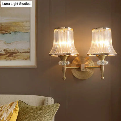 Mid-century brass crystal ribbed wall mounted lamp with two fluted glass shades and crystal accents for living room