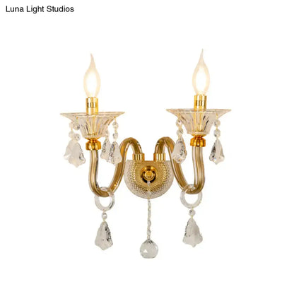 Mid-century brass crystal shade wall mounted sconce with gold-toned crystal chandelier and two candle-style bulbs