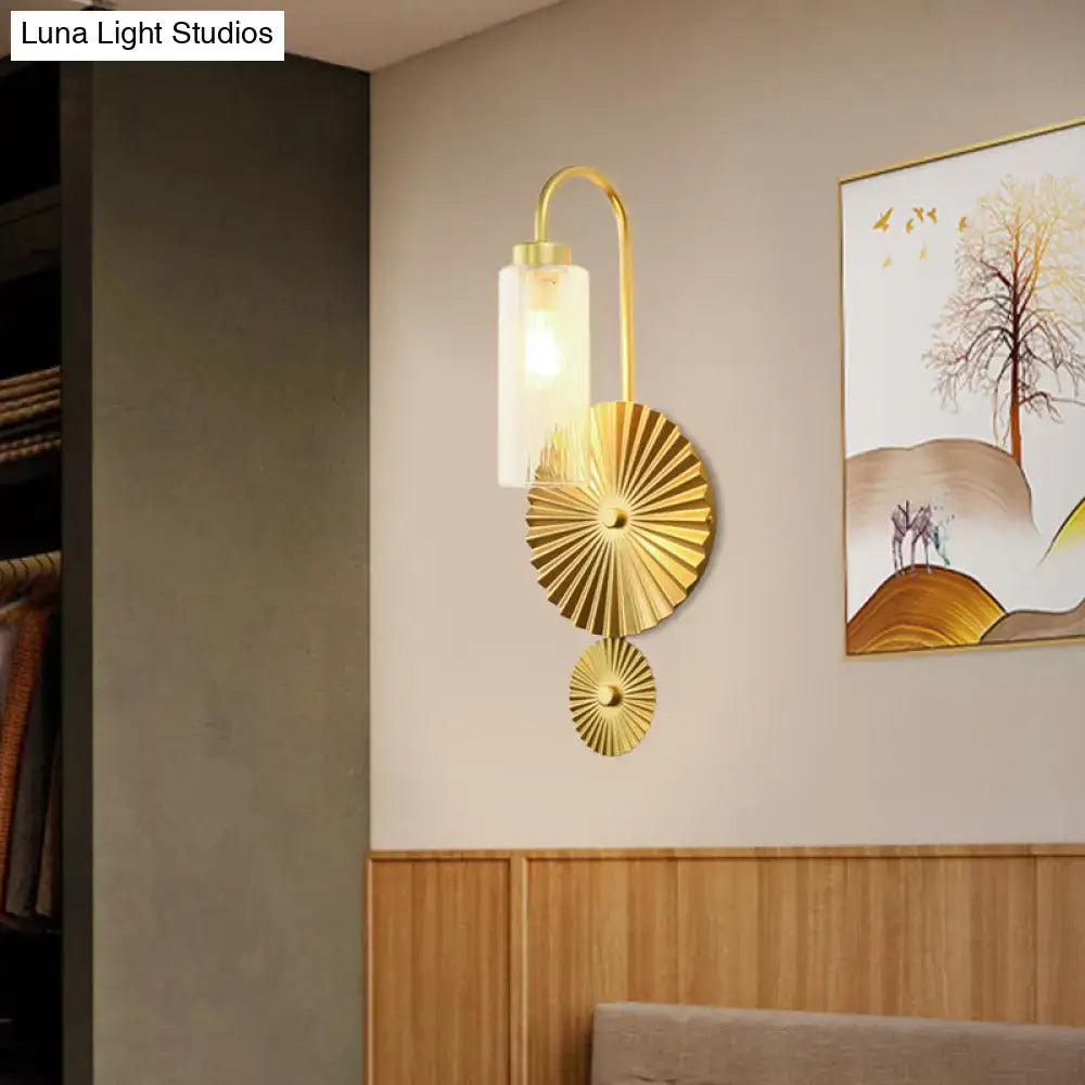 Gold-toned mid century brass gooseneck wall lamp with curved arm and sunburst fan decorative plates for bedroom use