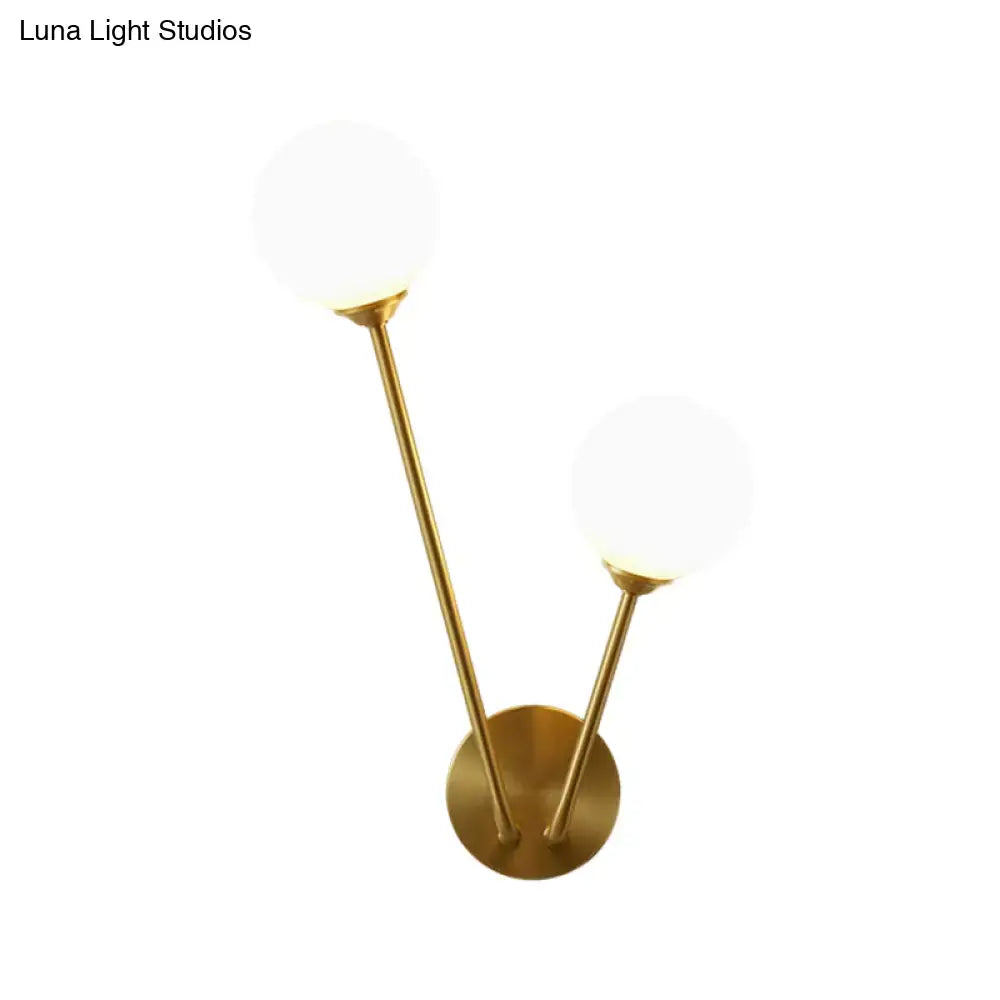 Mid century brass wall light with two opaline glass spherical shades and bulb base for living room use