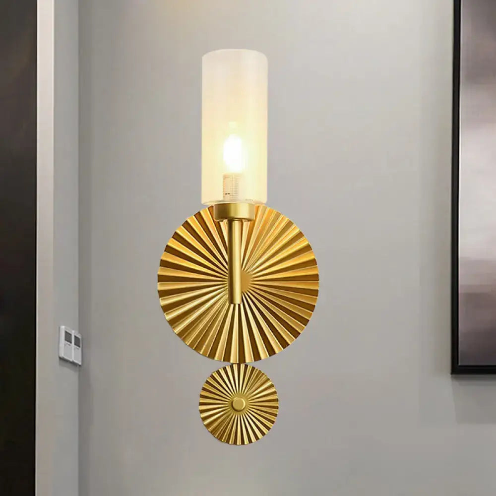 Mid century brass wall sconce with scalloped backplate gold tone and cylindrical frosted glass shade for bedroom use