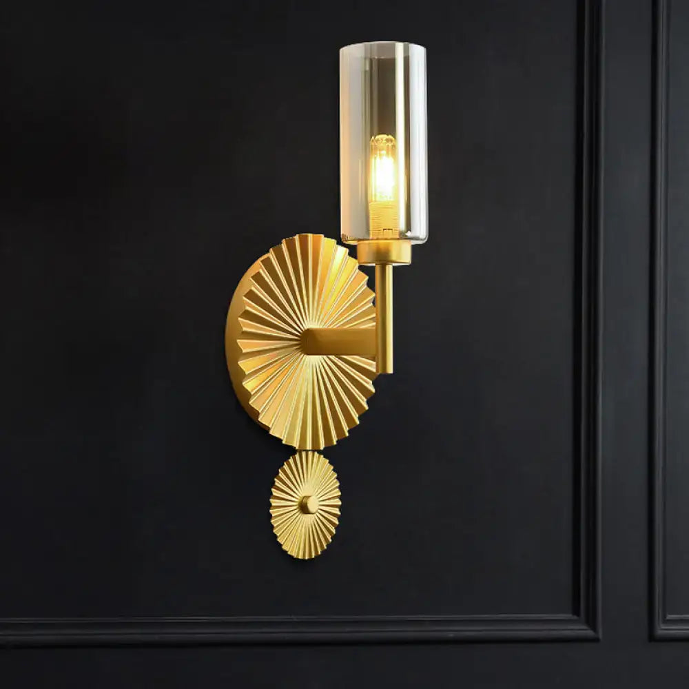 Mid century brass wall sconce with scalloped backplate amber glass shade and fan-like gold-toned metal plates