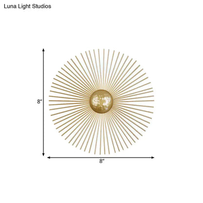 Mid century brass sunburst sconce light fixture features gold-toned metal with radiating spokes and a central orb