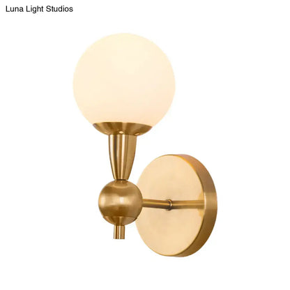 Brass-finished mid century wall mount light with frosted opal glass globe shade for 220v-240v and 110v-120v use