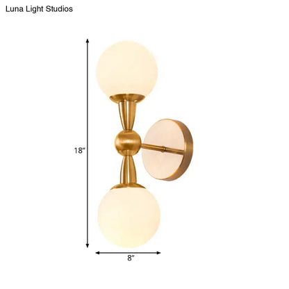 Gold-toned mid century wall mount light with two frosted opal glass globes suitable for 220v-240v and 110v-120v use