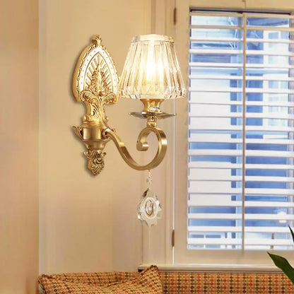 Mid century gold crystal wall sconce with faceted lampshade and dangling crystal ornament compatible with led incandescent light type