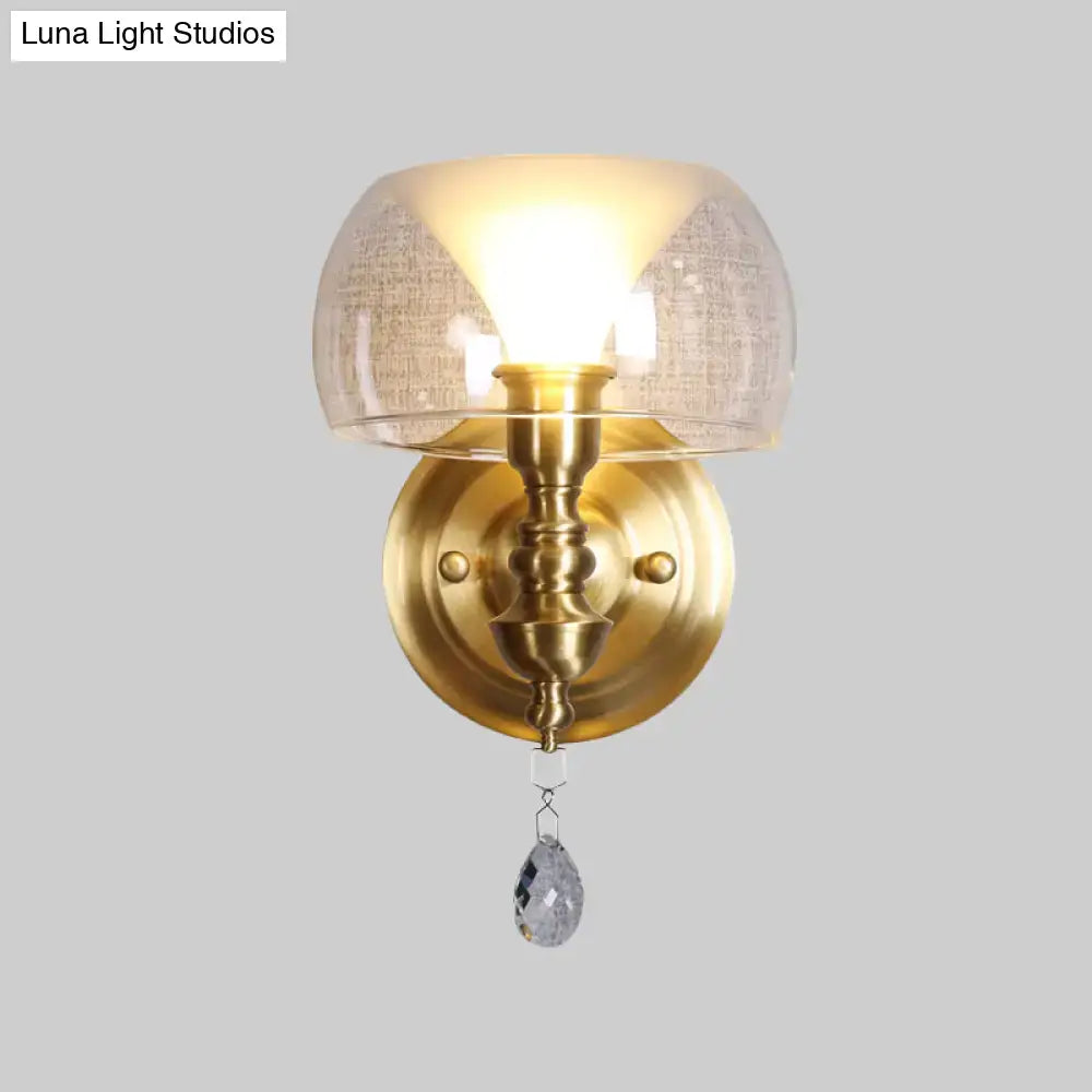 Antique brass mid century wall sconce with textured flared glass dome and dangling crystal droplet for bedroom