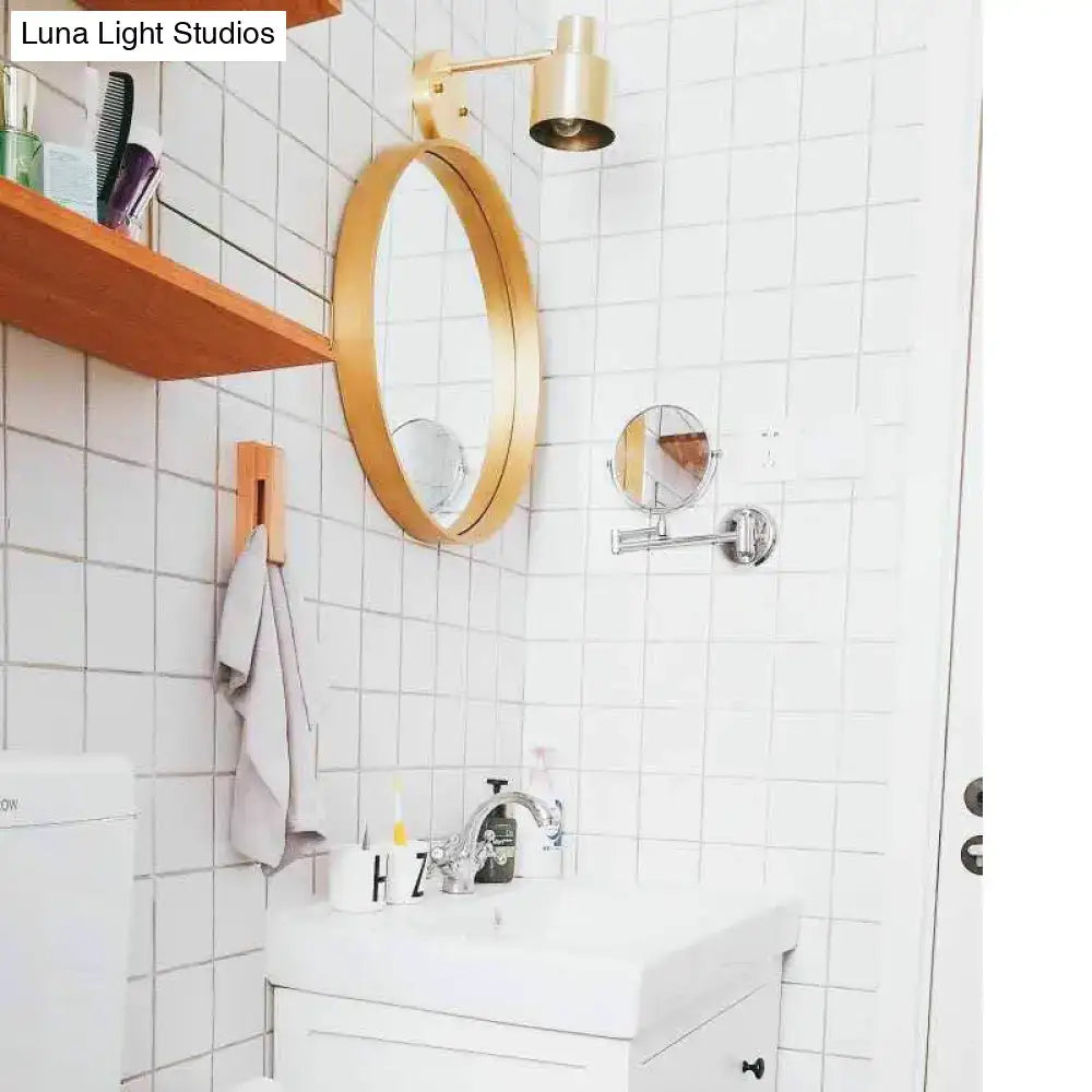 Gold-framed oval mirror above the sink with mid-century gold metal cage home wall lighting bedroom sconce