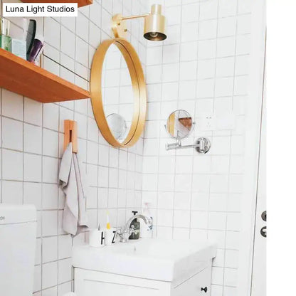 Gold-framed oval mirror above the sink with mid-century gold metal cage home wall lighting bedroom sconce