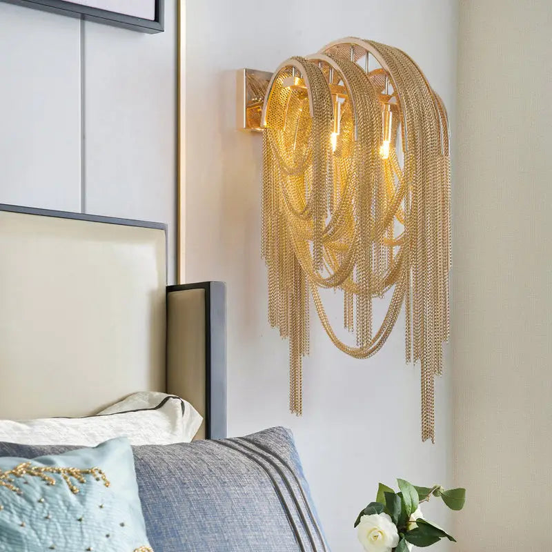 Mid century gold and silver stacked tassel wall lamp with cascading interwoven chain links for bedroom sconce