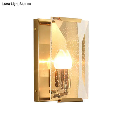 Mid century gold wall sconce with textured translucent glass panel and bulb base for elegant living room lighting
