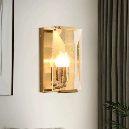Mid century gold wall sconce with rectangular frame frosted glass panels and bulb base for living room use