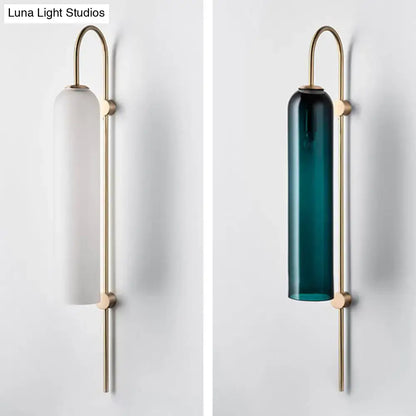 Modern mid century gooseneck wall light with a slender brass frame and frosted white or deep teal glass shade