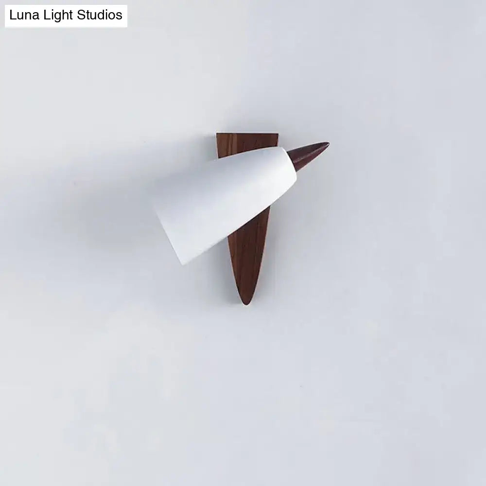 Mid-century white cone metal wall sconce with sleek white shade and dark wood triangular base for bedroom lighting