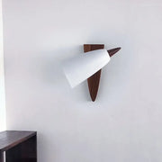 Mid-century white cone metal wall sconce with matte finish and dark wood triangular base for bedroom lighting