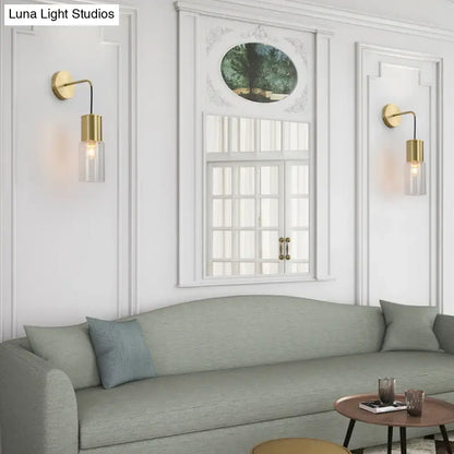 Minimal brass and glass wall sconce light with gold finish and clear glass shades for elegant bedroom lighting