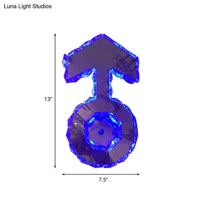 Minimal chrome faceted crystal boy logo wall lighting in translucent blue shaped like a male gender symbol