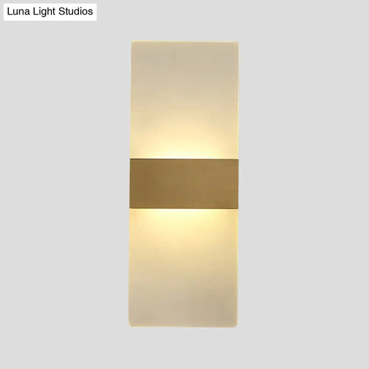 Minimalist acrylic gold wall sconce with a warm diffused glow and central gold-toned metallic accent bar wall lamp