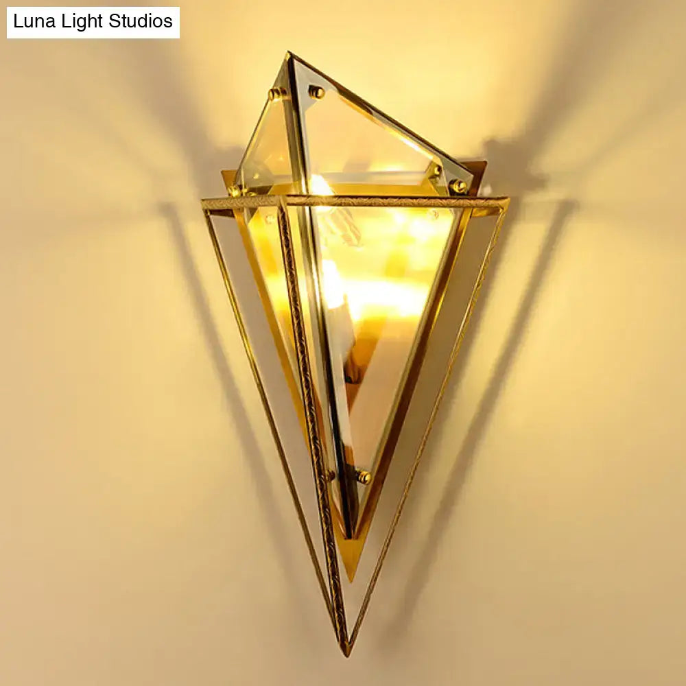 Minimalist geometric brass-framed diamond wall light with smoke gray and amber glass panels for living room